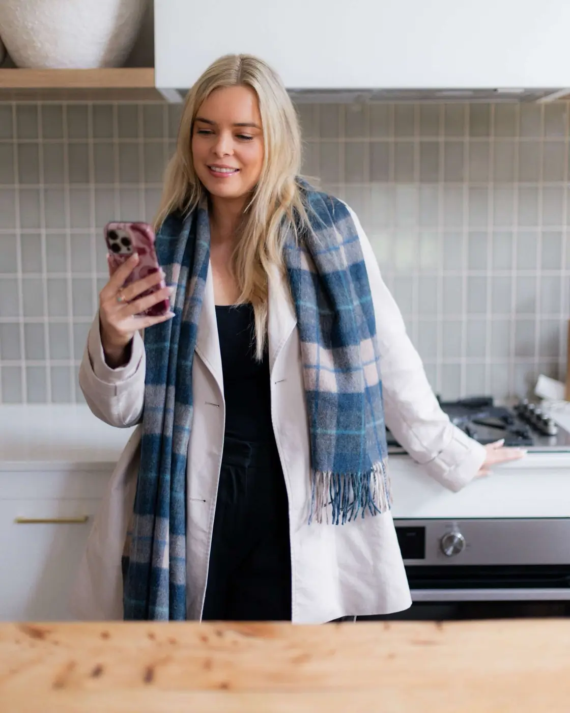 Charlotte from Comfy Creative filming content on her phone
