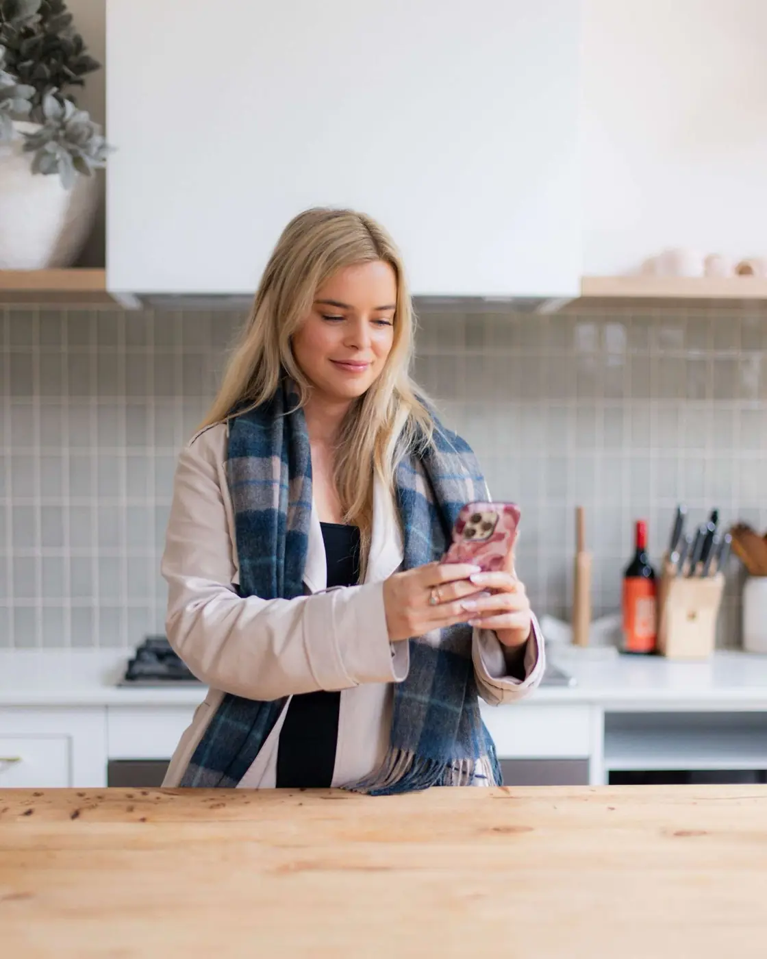 Charlotte from Comfy Creative checking ads on her phone