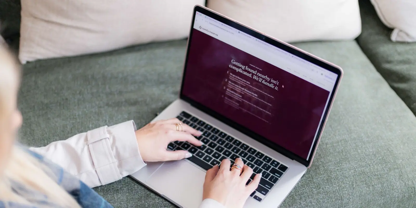 Charlotte working on a Comfy Creative website on her laptop
